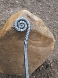 Ammonite style fire poker handcrafted in a blacksmiths forge