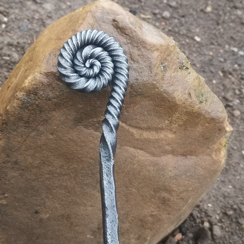 Ammonite style fire poker handcrafted in a blacksmiths forge