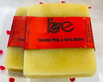 May include: Two bars of handmade coconut milk and shea butter soap with a red label that says "be" and "Coconut Milk & Shea Butter". The label also lists the ingredients: Coconut Milk, Shea Butter oil, Grapefruit oil, Limonene.