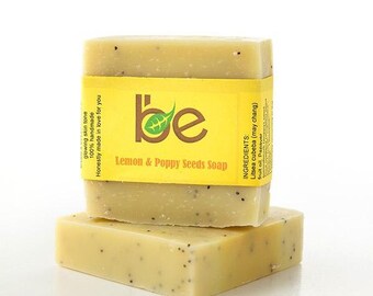 May include: Two bars of yellow and green handmade soap with poppy seeds. The label reads "be Lemon & Poppy Seeds Soap" and lists the ingredients as "Litsea cubeba (may chang) fruit oil, Papaver".