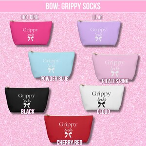 May include: Seven cosmetic bags with the text "Grippy Socks" and a bow design. The bags are in the colors hot pink, lilac, powder blue, pilates pink, black, cloud, and cherry red.