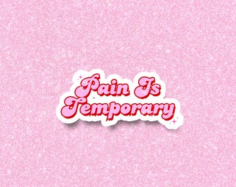 May include: A sticker with the words "Pain Is Temporary" in a retro font. The text is pink with a red outline and a white border. The background is a light pink glitter.
