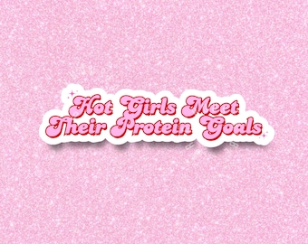 May include: Pink glitter background with a white sticker that says "Hot Girls Meet Their Protein Goals" in red letters with a retro font.