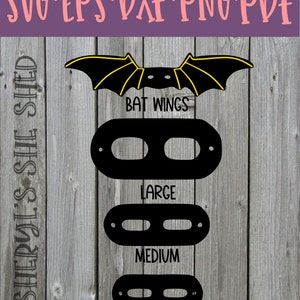 May include: Black bat wings with yellow accents, and three black shapes with cutouts, labelled "Large", "Medium", and "Small".