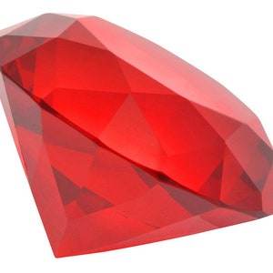 May include: A large, red, faceted, crystal diamond. The diamond is cut in a classic shape with many facets.