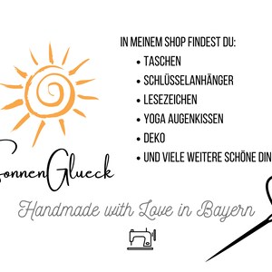 May include: A logo for a shop called "Sonnen Glueck" that sells handmade items. The logo features a sun with a swirl in the center and the text "Handmade with Love in Bayern".