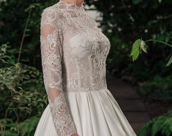 Lace wedding dress with long sleeves. Satin skirt wedding dress. Long sleeves bridal gown. A line wedding dress. Classic bridal gown.