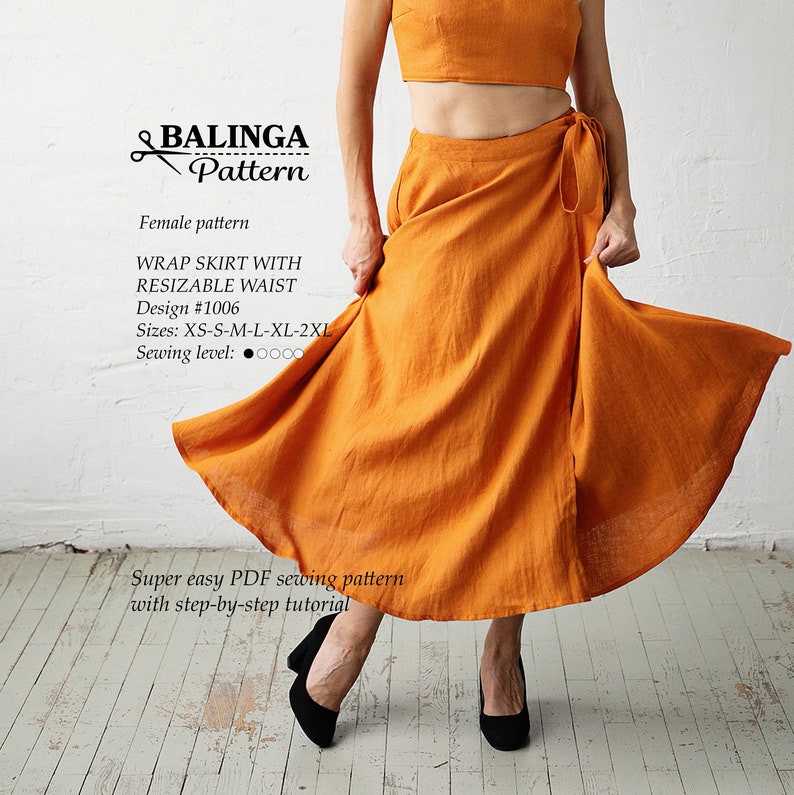 May include: A bright orange wrap skirt with a tie at the waist. The skirt is made of a lightweight fabric and has a flowing silhouette. The text "BALINGA Pattern" is at the top of the image. The text "WRAP SKIRT WITH RESIZABLE WAIST" is below the pattern name. The text "Design #1006" is below the skirt description. The text "Sizes: XS-S-M-L-XL-2XL" is below the design number. The text "Sewing level: 0000" is below the sizes. The text "Super easy PDF sewing pattern with step-by-step tutorial" is at the bottom of the image.