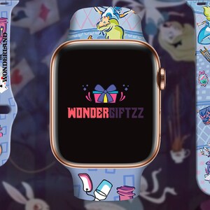 May include: A blue Apple Watch band with a white and blue Alice in Wonderland design. The band features characters and objects from the story, including Alice, the Mad Hatter, and a teapot. The watch face displays the text "WONDERSIFTZZ".