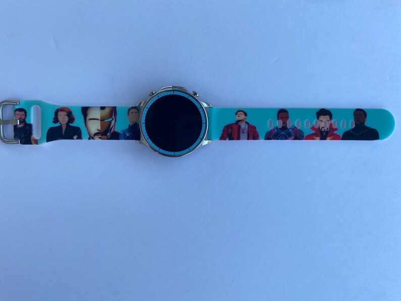 May include: A turquoise smartwatch band with a black screen and a print of various Marvel characters, including Iron Man, Black Widow, and Captain America.