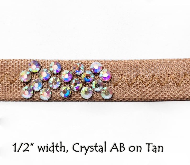 May include: Tan ribbon trim with a row of iridescent crystal AB rhinestones, 1/2 inch wide.