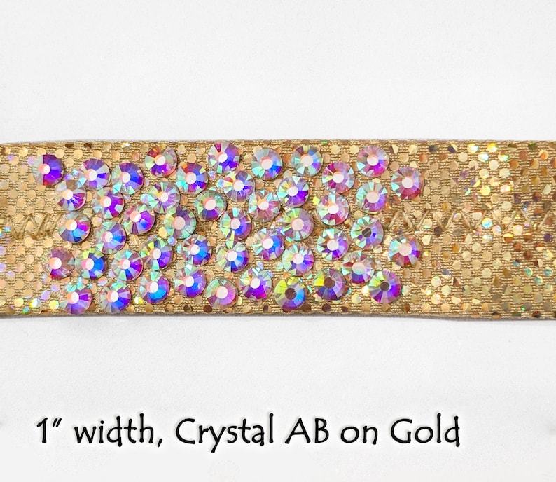 May include: Gold fabric trim with a row of iridescent crystal rhinestones. 1" wide.