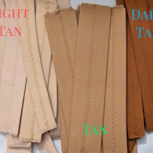 May include: Two stacks of fabric strips, one light tan and one dark tan. The strips are sewn with a zig-zag stitch.