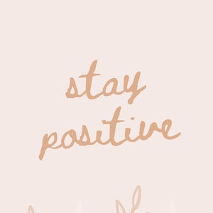 May include: A light pink background with the text "stay positive" in brown script. The bottom of the image features a border of brown and white stylized leaves.