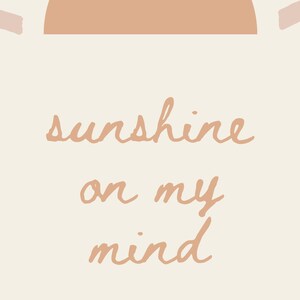 May include: A digital illustration of a sunset with the text "sunshine on my mind" in a peach color.