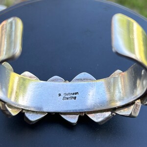 May include: Silver bracelet with turquoise stones and a hallmark that reads "D. Johnson Sterling".