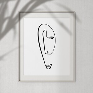 Puede incluir: Un dibujo en blanco y negro de una cara en un estilo simple y minimalista. La cara est&aacute; dibujada con una sola l&iacute;nea continua, creando una sensaci&oacute;n de movimiento y fluidez.