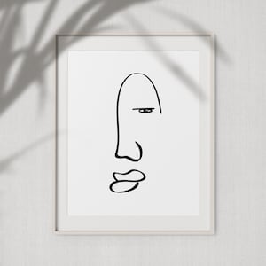 Può includere: Un disegno in bianco e nero di un viso con un solo occhio, naso e bocca. Il disegno è incorniciato in una cornice bianca.