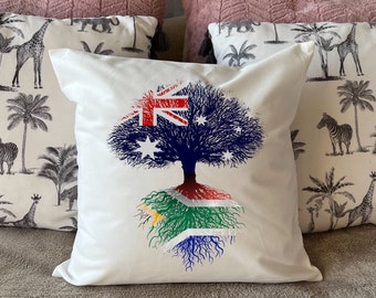 South African heritage cushion Australian flag tree with South African flag roots. Plush white cushion, ideal gift.