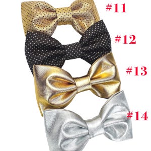 May include: Four bow ties in gold, black with white polka dots, metallic gold, and silver. Each bow tie is tied and ready to wear. The bow ties are labeled with the numbers 11, 12, 13, and 14 in red.