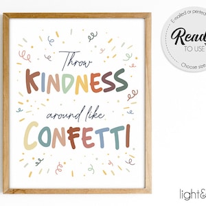 Könnte beinhalten: Ein gerahmter Druck mit dem Text "Throw KINDNESS around like CONFETTI" in farbenfrohen, verspielten Buchstaben. Der Druck hat einen hellen Holzrahmen und Konfetti-ähnliche Illustrationen.