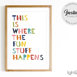 May include: A framed print with the text "THIS IS WHERE THE FUN STUFF HAPPENS" in colorful letters. The print is in a light wood frame.