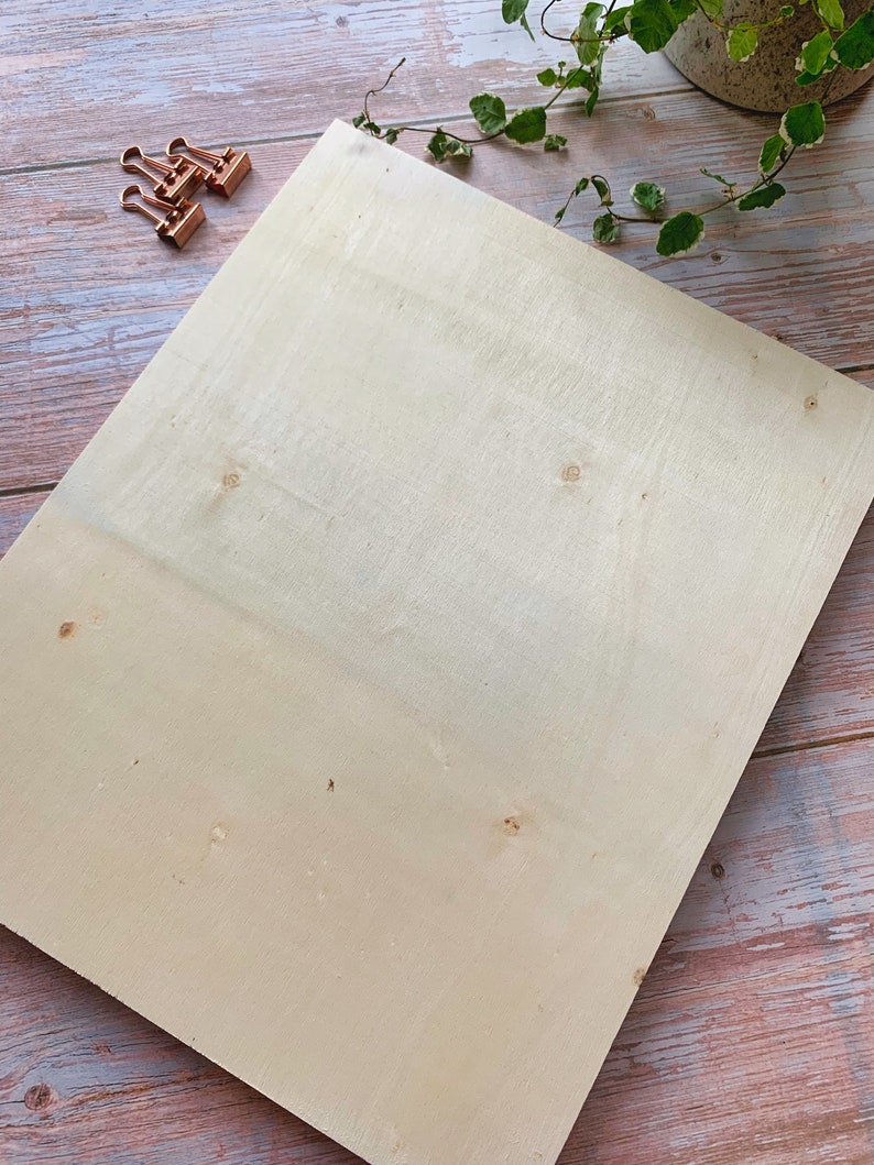 May include: A large, rectangular piece of light-colored wood with a smooth surface. The wood has a few small knots and is slightly textured.