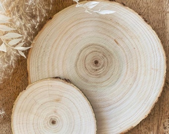 May include: Two round wooden slices, one larger than the other, with a natural wood grain pattern. The slices are light brown in color and have a smooth, polished surface.