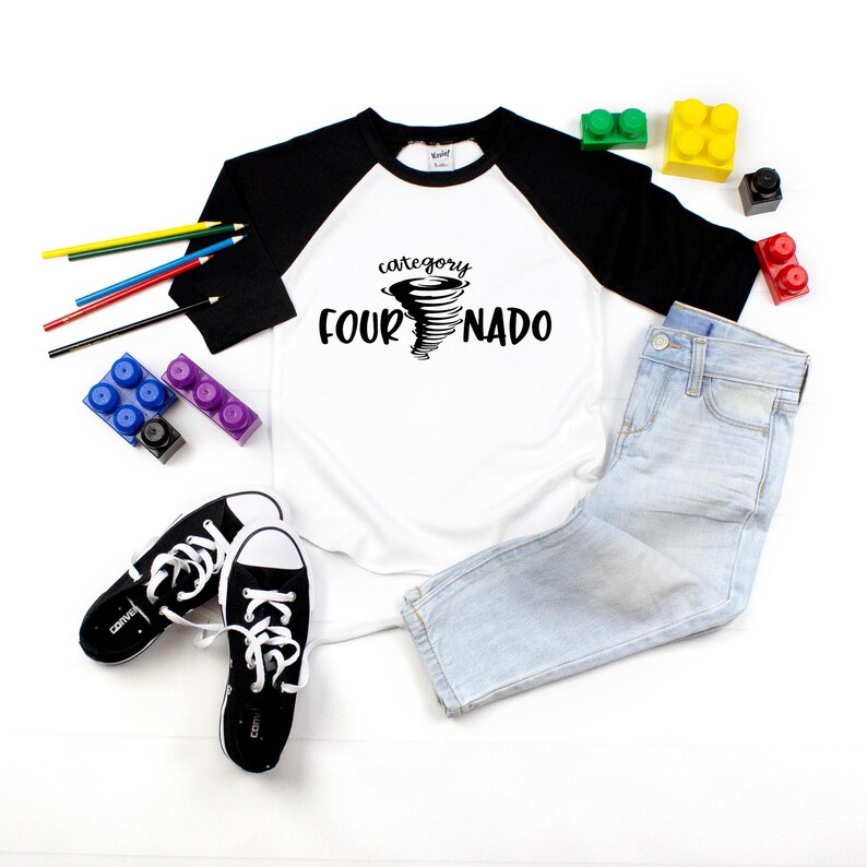 May include: White and black baseball tee shirt with a black tornado graphic and the text "category four NADO".