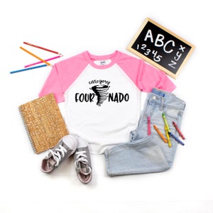 May include: White and pink baseball tee shirt with a black graphic of a tornado with the text "category four-nado".