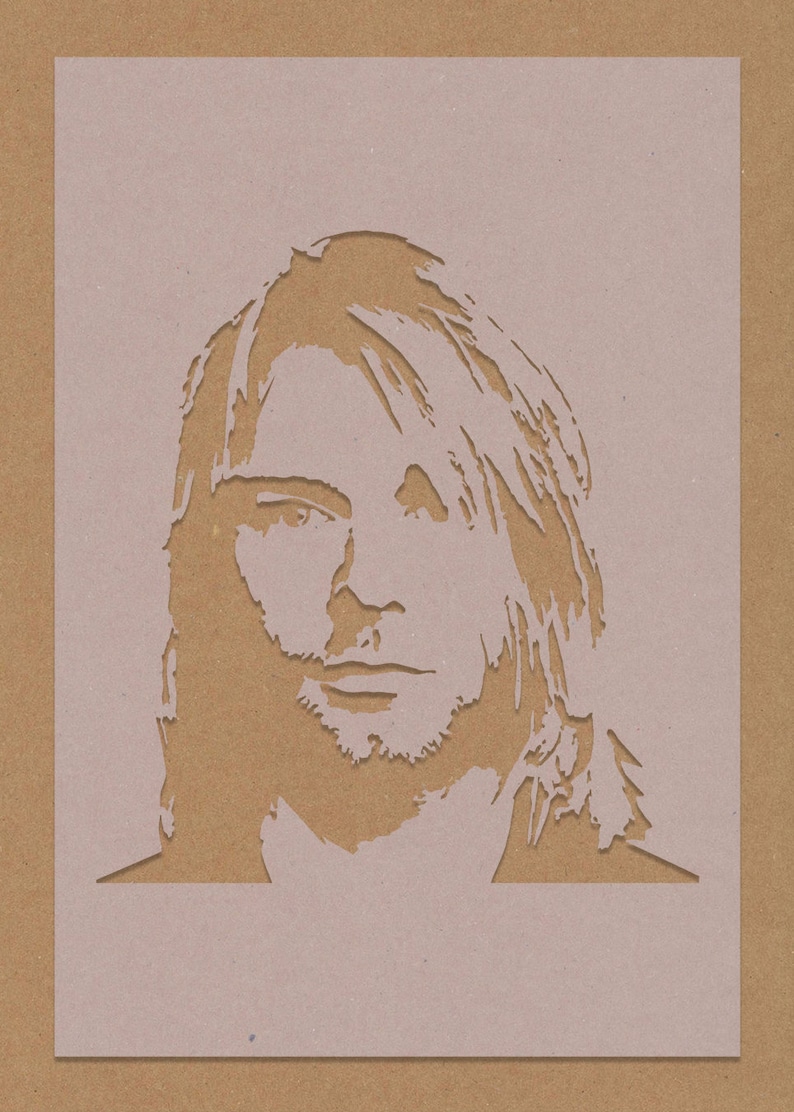 May include: A stencil of a person's face with long hair. The stencil is cut out of brown paper and is on a light brown background.
