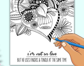 May include: A black and white colouring page featuring a heart-shaped design with intricate details. The text "i'm not in love BUT HE USES FINGERS & TONGUE AT THE SAME TIME" is written below the design.