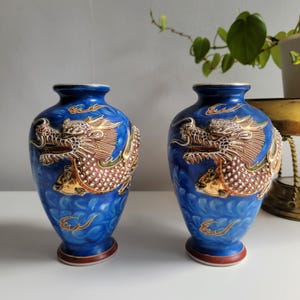 Collectable Antique Japanese Blue vase pair with embossed dragon motive
