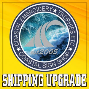 May include: A blue and white logo with a wave design and the text "Coastal Embroidery Trophies Etc. Est 2005 Coastal Sign Shop" in a white circle with a blue border. The text "Shipping Upgrade" is in white letters on a yellow background.