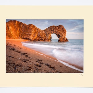 7x5″, A4 or A3 photograph in ivory mount with oak or black photo frame options featuring photography of the arch at Durdle Door in Dorset.