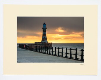 7x5″, A4 or A3 photo in ivory or white mount with oak or black frame option featuring photography of Roker Lighthouse at sunrise, Sunderland