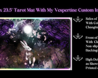 May include: A tarot mat with a custom image of a white rabbit, two purple owls, and a full moon in a forest setting. The mat is 13.5 inches by 23.5 inches and has a non-slip rubber backing. The sides of the mat light up with color-changing LEDs.