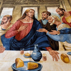 May include: A fabric panel depicting the Last Supper. The image features Jesus and his disciples gathered around a table with food and drink. The artwork is rendered in warm tones, with figures in robes and a detailed architectural background.