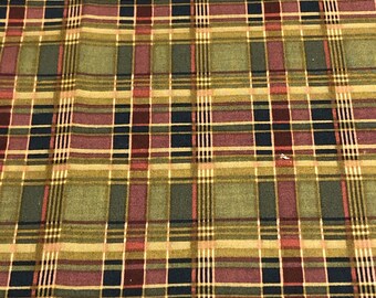 May include: A plaid fabric with a pattern of red, green, brown, and black squares.