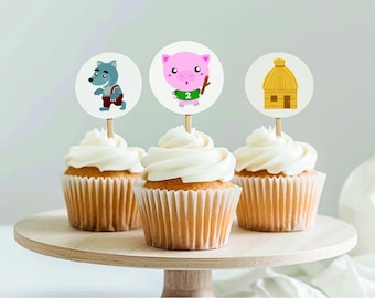 May include: Three cupcakes with white frosting and different toppers. The toppers are a cartoon wolf, a cartoon pig, and a cartoon straw house.