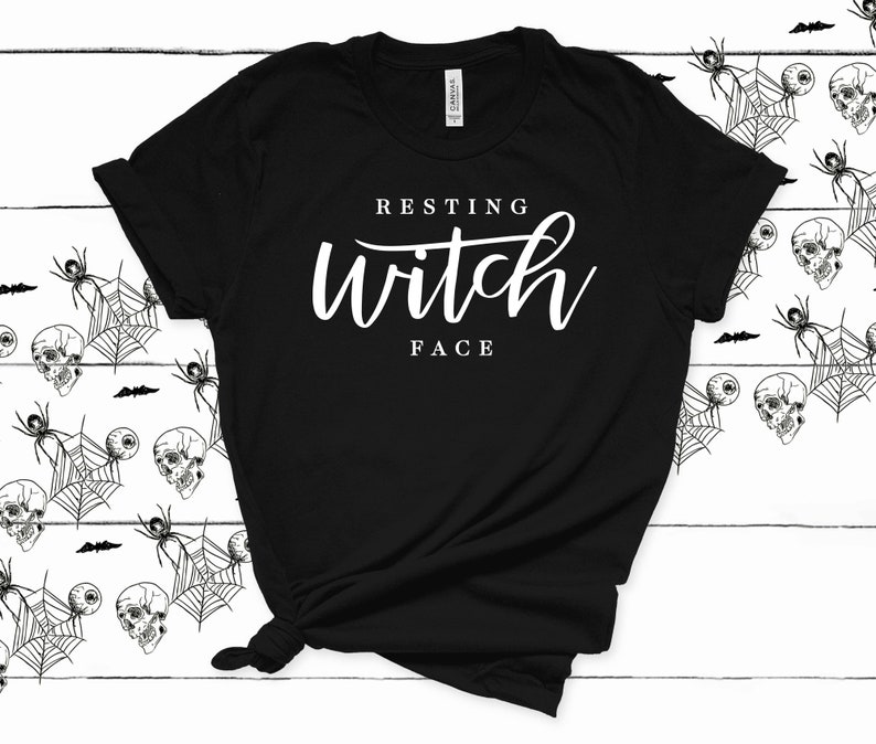 May include: Black t-shirt with white text that reads "Resting Witch Face".