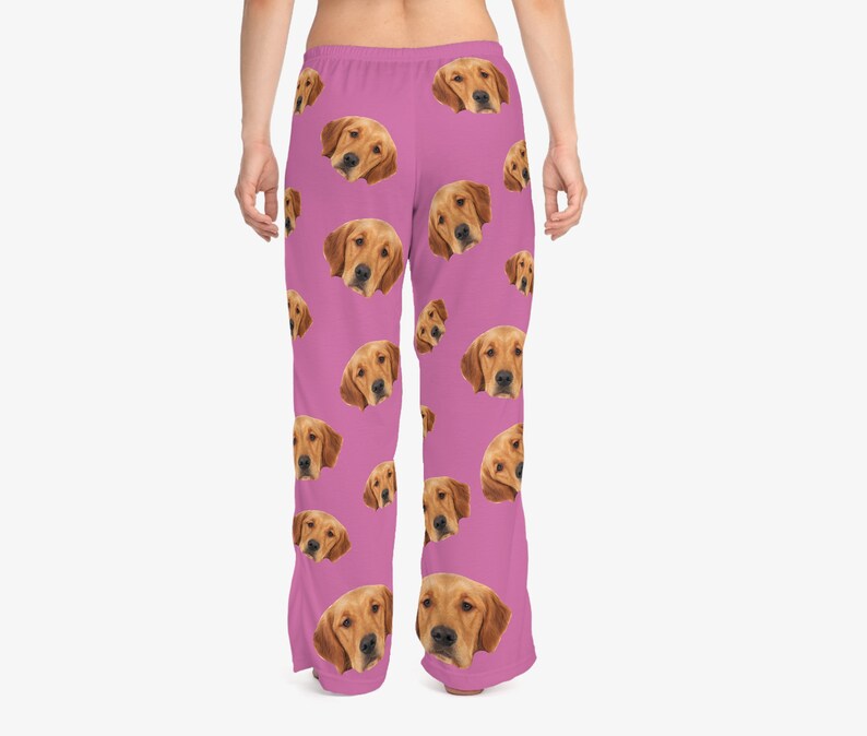 May include: Pink pajama pants with a repeating pattern of a golden retriever's face.