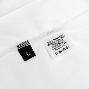 May include: White clothing label with black trim and text that reads "100% Polyester Machine Wash Cold Gentle Cycle Do Not Bleach Tumble Dry Low Do Not Iron" and a black size tag that reads "L".