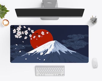 May include: A blue and white desk mat with a red sun and a mountain range. The mountain range is covered in snow and there are cherry blossoms in the upper left corner.
