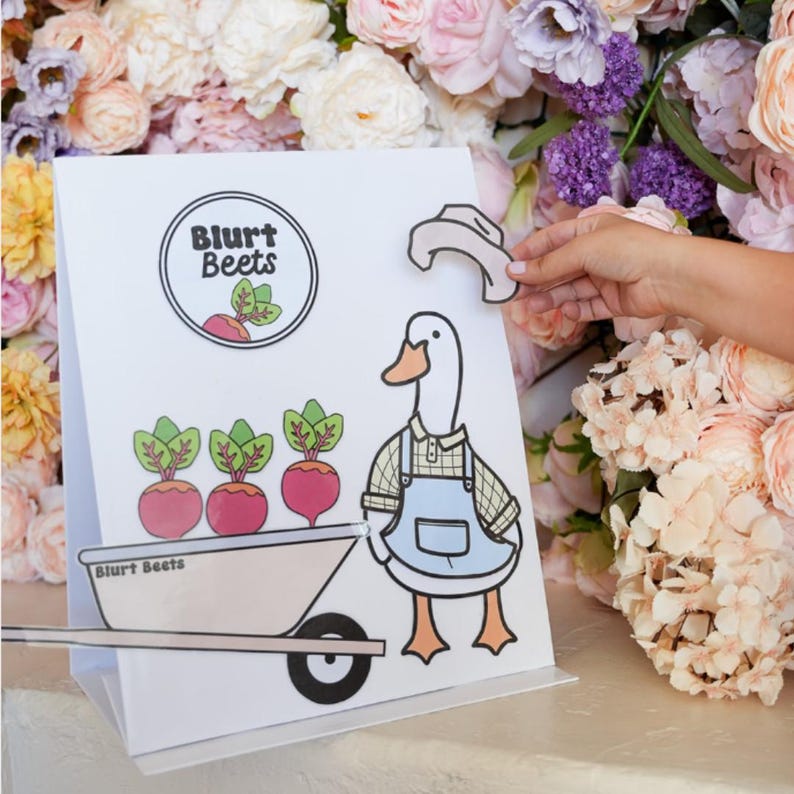 May include: A white sign featuring a cartoon goose wearing a blue overall and a white hat. The goose is pushing a wheelbarrow containing three red beets. The sign reads "Blurt Beets" in a black circle.