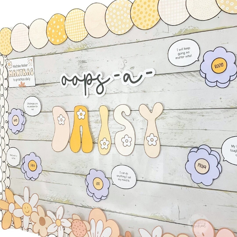May include: A classroom bulletin board decorated with a daisy theme. The board features the words "oops-a-DAISY" in large, colorful letters. There are also several smaller daisy-shaped cutouts with positive affirmations written on them, such as "I will keep going no matter what" and "I can do anything I set my mind to".