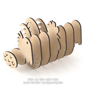 May include: A light-colored wooden 3D puzzle shaped like a rooster, composed of multiple interlocking flat laser-cut panels. The design features a layered silhouette with visible grain, and the text SVG AI EPS DXF PDF Laser Cut File by SquareOptics.