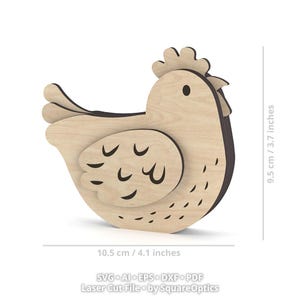 May include: A light-colored wooden chicken cutout with dark brown edges, featuring engraved wing and feather details. The object measures 10.5 cm / 4.1 inches in width and 9.5 cm / 3.7 inches in height. Text at the bottom reads SVG, AI, EPS, DXF, PDF.