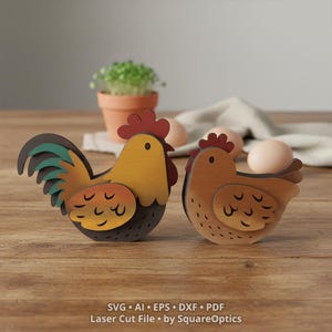 May include: Two layered wooden chicken figures, one with a yellow body and green tail feathers, the other with a light brown body, both featuring dark brown wing details. Text at the bottom reads: SVG AI EPS DXF PDF Laser Cut File by SquareOptics.