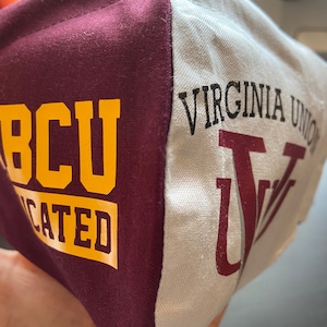 Pode incluir: Uma máscara facial de cor vinho e branca com o texto "VCU Educated" em amarelo no lado vinho e "VIRGINIA UNION" em preto com um "V" vinho no lado branco.